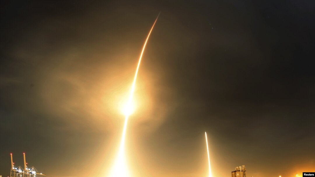 FILE - A long-exposure photograph shows the SpaceX Falcon 9 lifting off (L) from its launch pad and then returning to a landing zone (R) at the Cape Canaveral Air Force Station, in Cape Canaveral, Florida, Dec. 21, 2015.