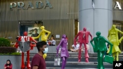People wearing protective face masks walk along the Orchard Road shopping area in Singapore on Nov. 28, 2021. 