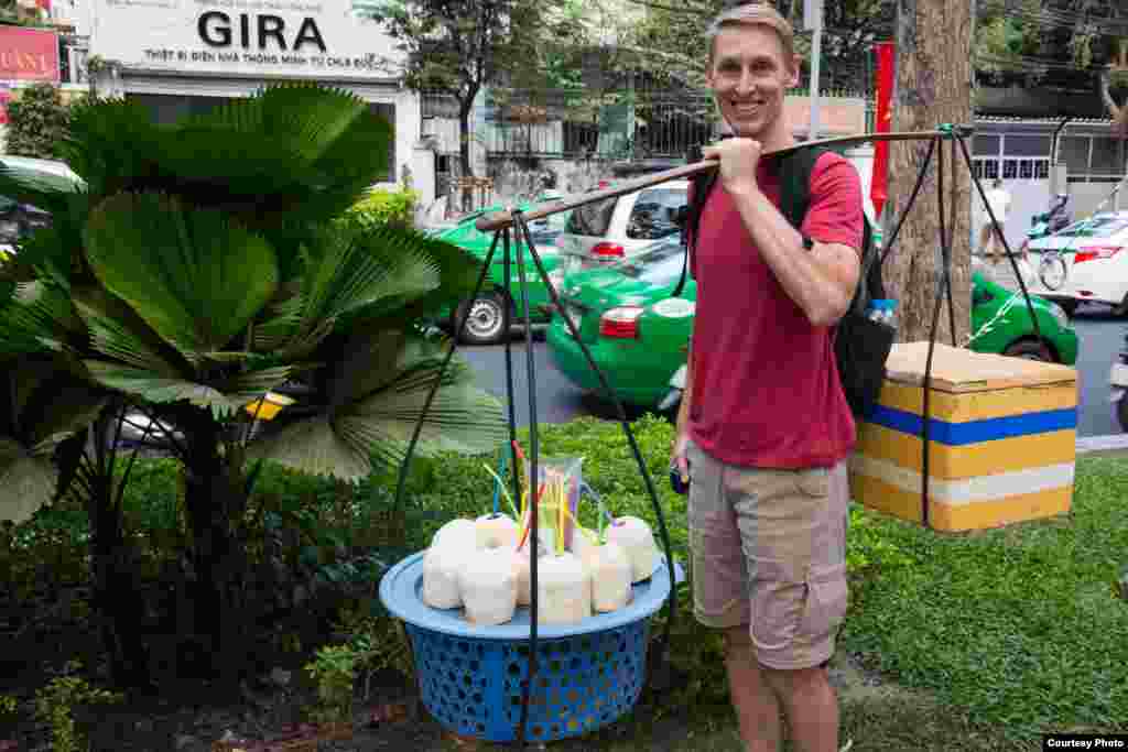 Ông Rivenbark thử gánh quang gánh ở thành phố Hồ Chí Minh.