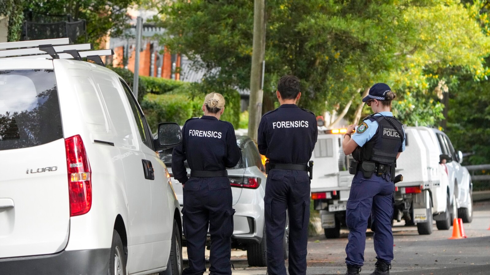 FILE - Police stand near houses vandalized with anti-Israel slogans in the Sydney suburb of Woollahra, Australia, Wednesday, Dec. 11, 2024. 
