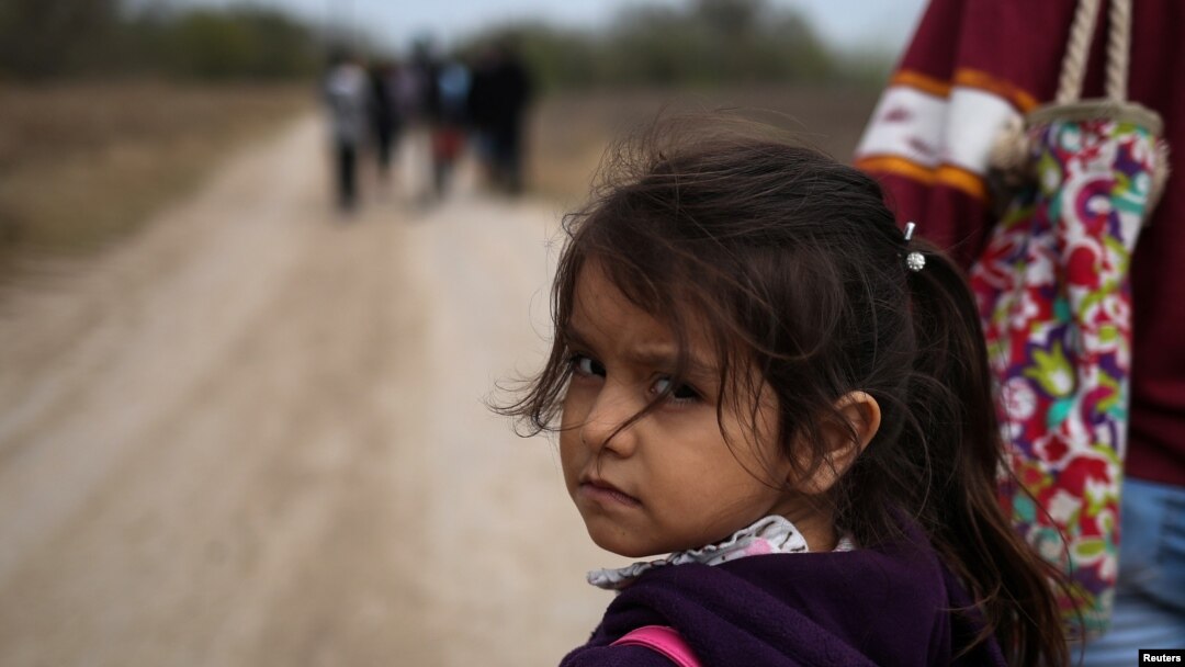 FILE - Alondra Poula, a five-year-old migrant from Nicaragua seeking asylum, walks down a dirt road with her mother after illegally crossing the Rio Grande river into the U.S. from Mexico in Penitas, Texas, Jan. 10, 2019. 