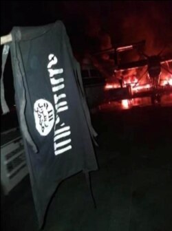 An image distributed by al-Shabab after the attack on a military base in Kenya shows Somalia's al-Shabab militant group's flag, said to be at the Manda Bay Airfield in Manda, Lamu, Kenya, Jan. 5, 2020.
