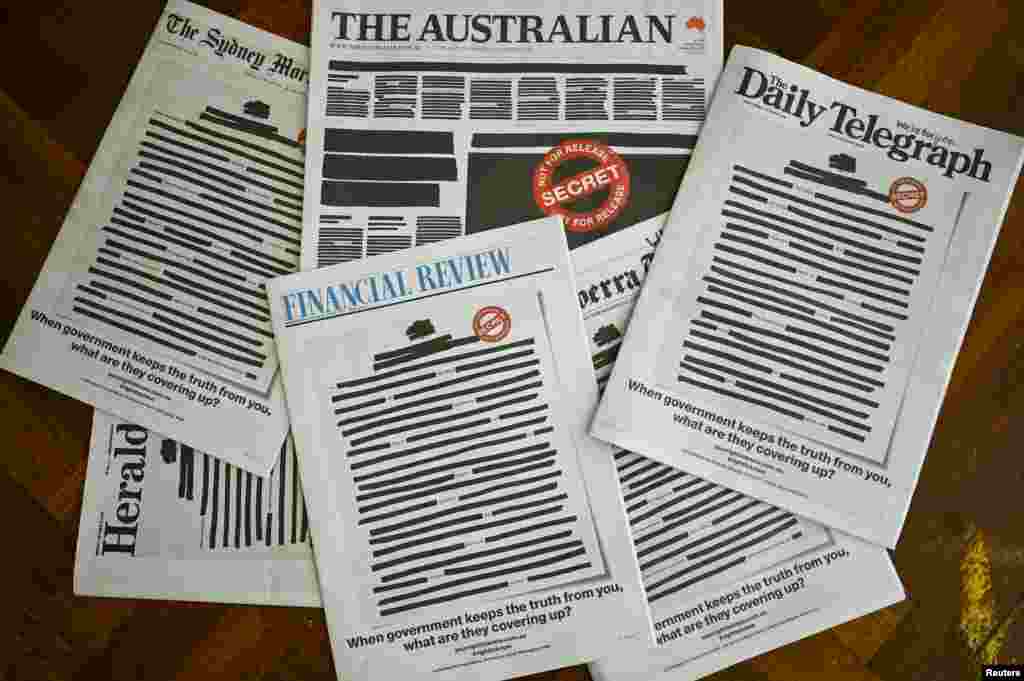 Front pages of major Australian newspapers show a 'Your right to know" campaign, in Canberra. Australia's biggest newspapers ran front pages made up to appear heavily redacted to protest against recent legislation that restricts press freedoms. (AAP Image/Lukas Coch) 