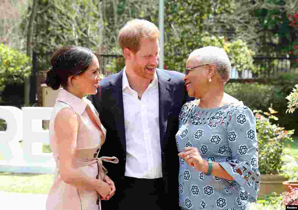 Britain's Prince Harry and his wife Meghan, the Duke and Duchess of Sussex, meet Graca Machel, the widow of the late Nelson Mandela, in Johannesburg, South Africa.
