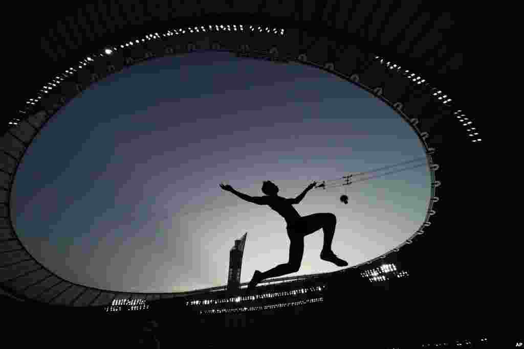 An athlete competes during the qualifications for the men's long jump event at the World Athletics Championships in Doha, Qatar.