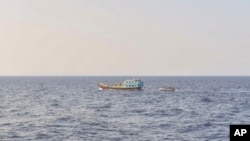 In this photo released by the U.S. Navy, sailors intercept a dhow in the Gulf of Oman on Nov. 8, 2022.