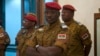 FILE - Burkina Faso Prime Minister Yacouba Isaac Zida listens as an official reads the names of transitional government ministers, in Ouagadougou, Burkina Faso.