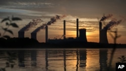 FILE - A coal-fired plant is seen emitting carbon dioxide, in Juliette, Georgia, June, 3, 2017. 