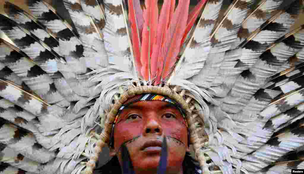 An indigenous leader of the Huni Kuin Kaxinawa from Brazil joins a protest against the Brazilian government's environmental polices, outside of the Brazilian Embassy in London, Britain.