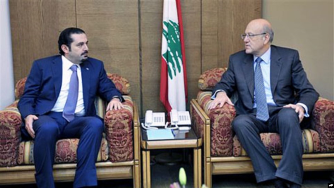 Lebanon's PM-designate Najib Mikati (R) meets with caretaker PM Saad Hariri (L) at the Parliament during consultations to form a new cabinet, Beirut, Jan 27 2011