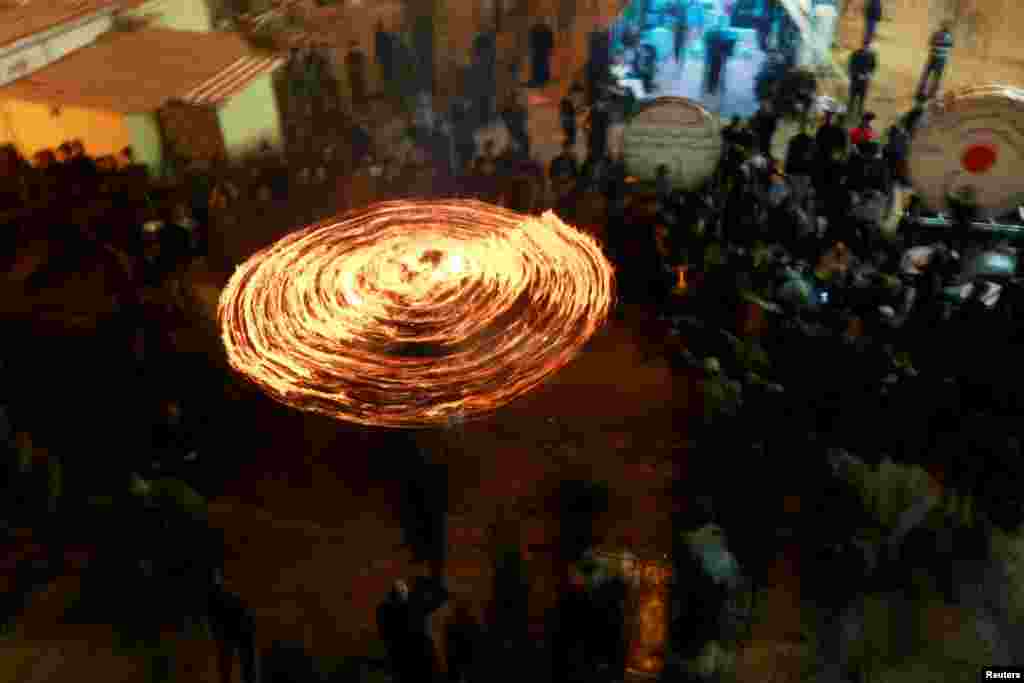 Shi'ite Muslims perform with fire during commemorations for Ashura in Najaf, Iraq, Sept. 7, 2019.