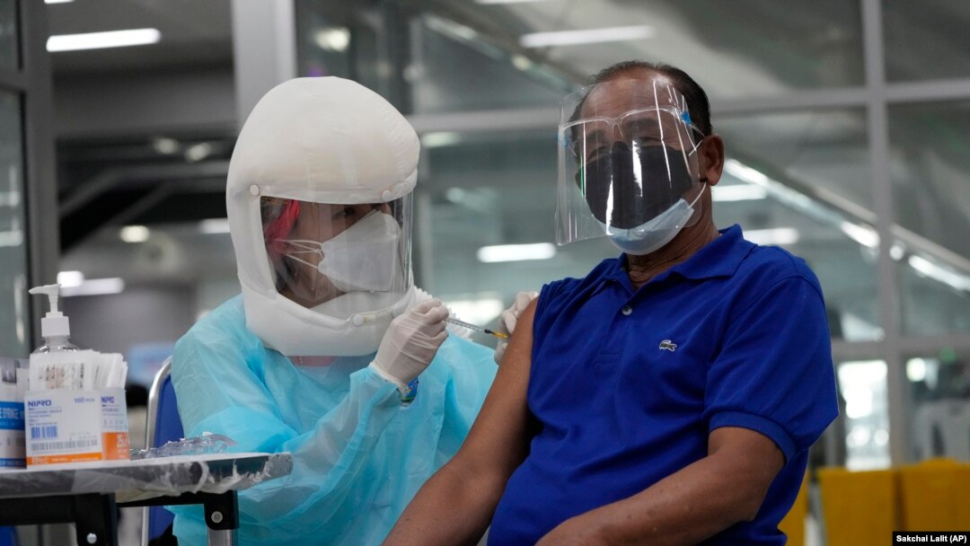 A health worker administers shots of the AstraZeneca COVID-19 vaccine at the Central Vaccination Center in Bangkok, Thailand, Thursday, July 22, 2021.