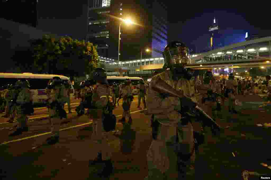 香港防暴警察手持催淚彈發射器與抗議者對峙。抗議者堵住了通往港府外面的金融中心區的主要道路。(2014年9月28日)