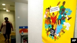 FILE - A sign adorns a wall at United Fort Worth, a grassroots community organization in Fort Worth, Texas, Aug. 10, 2021. New Census Bureau data show the nation's changing racial numbers.