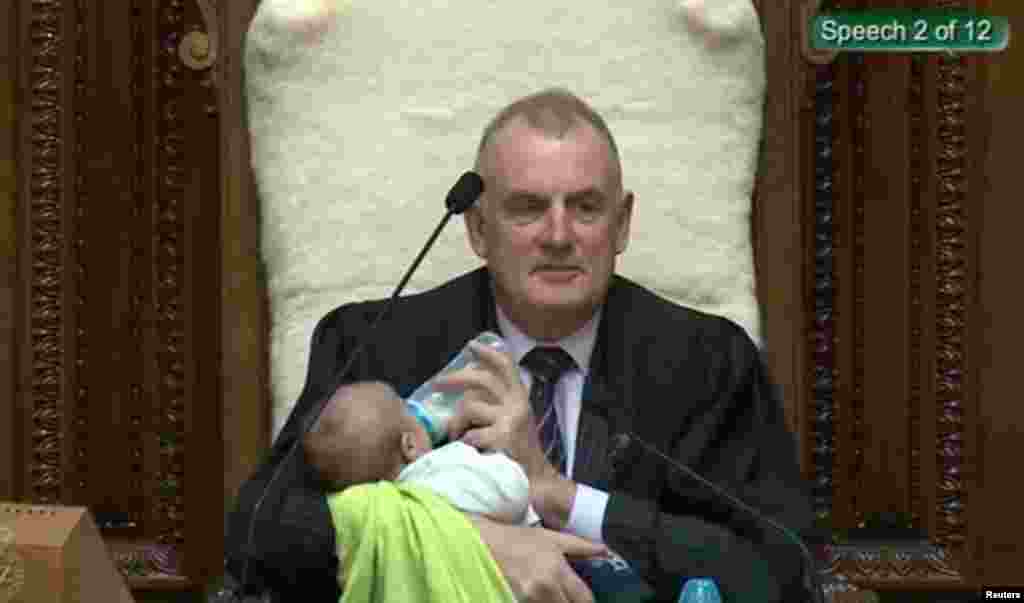 Screenshot from a Parliament broadcast of New Zealand Speaker Trevor Mallard feeding a Member of Parliament’s baby during a parliamentary session in Wellington, Aug. 21, 2019. (New Zealand Parliament and Speaker's Office/Handout)