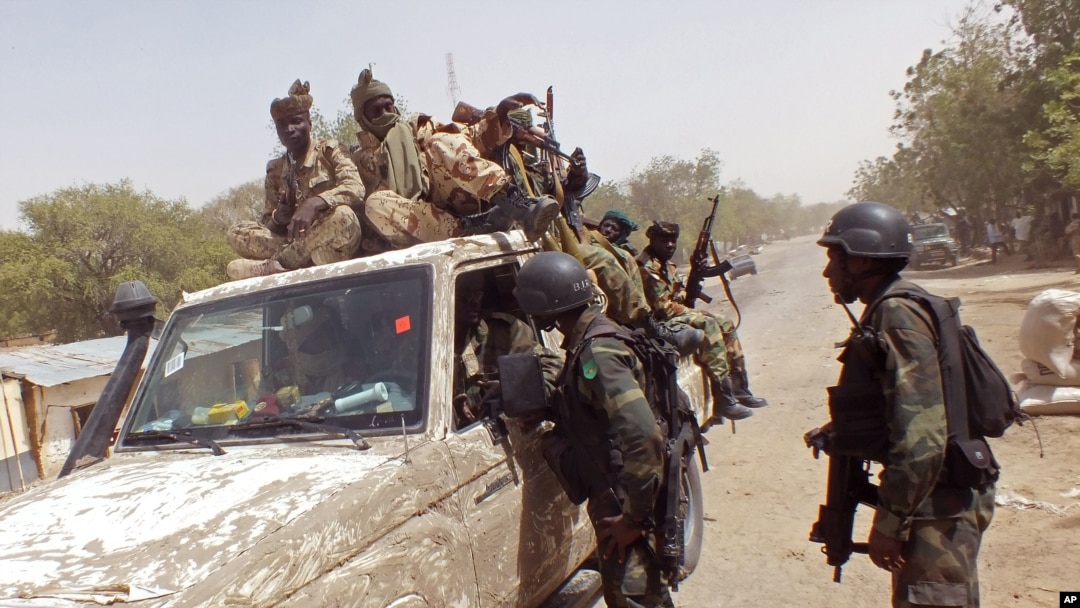 In this photo taken Feb. 19, 2015, Cameroon soldiers check a truck on the border between Cameroon and Nigeria as they combat regional Islamic extremists force's including Boko Haram.