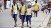 FILE - Schoolchildren walk in the street in Lagos, Nigeria, June 17, 2014. 