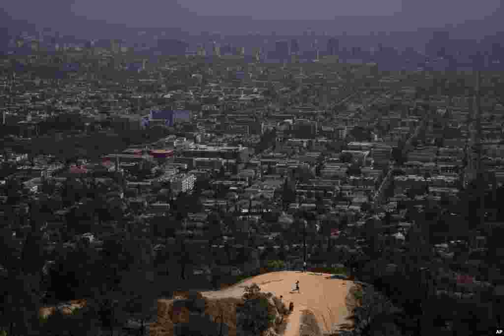 A jogger runs along a Griffith Park trail in Los Angeles, California, May 3, 2021. Los Angeles County is expected to move into the least-restrictive yellow tier this week, amid the coronavirus pandemic.