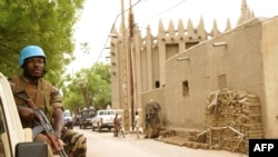 FILE - A peacekeeper with the United Nations patrols outside the mosque in Mopti, central Mali, May 30, 2018. Attackers raided a village in the central Mopti region Tuesday, killing 37 civilians, according to reports.
