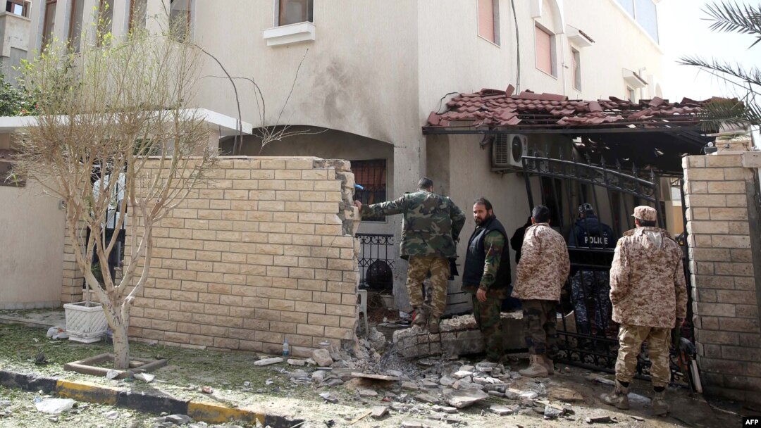 Libyan security forces inspect the site of a bomb explosion at the entrance of the residence of the Iranian ambassador in the capital Tripoli, Feb. 22, 2015.