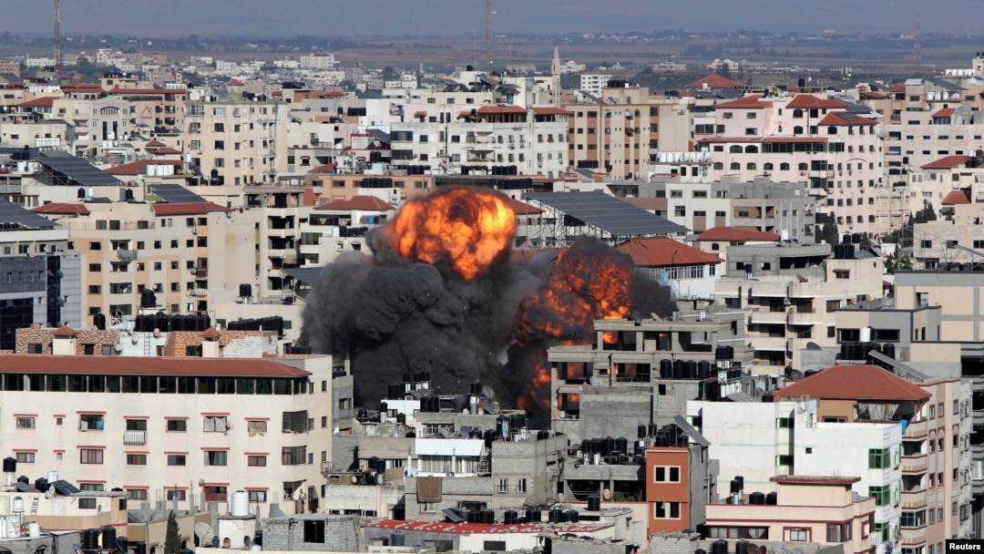 Smoke and flames rise during an Israeli airstrike, amid a flare-up of Israeli-Palestinian violence, in Gaza City, May 14, 2021. 