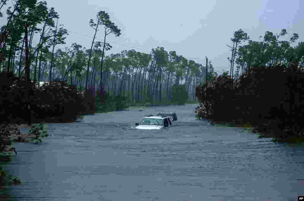 Cars sit submerged in water from Hurricane Dorian in Freeport, Bahamas. Dorian is beginning to inch northwestward after being stationary over the Bahamas, where its relentless winds have caused catastrophic damage and flooding.