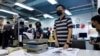 Staff members of Apple Daily work on their final edition in Hong Kong, July 21, 2021.