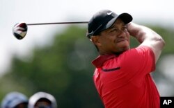 Tiger Woods hits from the third tee during the final round of the Cadillac Championship golf tournament, March 9, 2014, in Doral, Florida.