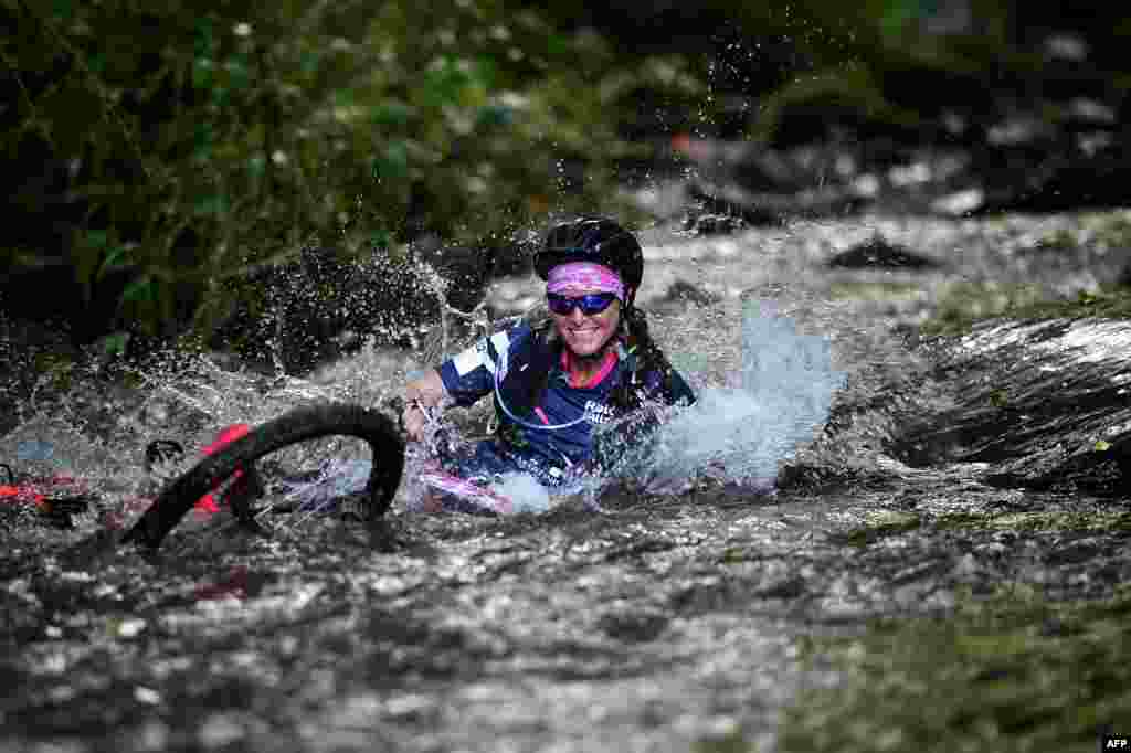 A woman competes in the mountain bike race as part of the "Raid des Alizes", an exclusively all-female multi-sport competition on the French Caribbean island of Martinique.