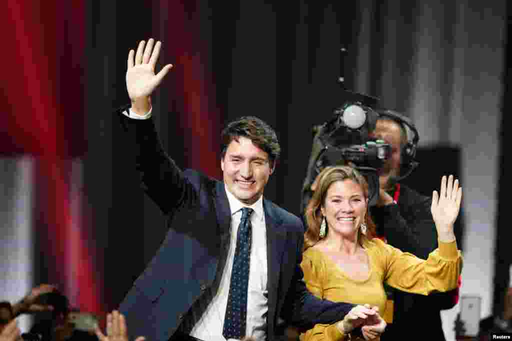 Canadian Prime Minister Justin Trudeau and his wife Sophie Gregoire Trudeau wave to supporters after the federal election at the Palais des Congres in Montreal, Quebec. Trudeau's Liberals held onto power after a closely fought election but were reduced to a minority government that will need the support in Parliament of a smaller left-leaning party.