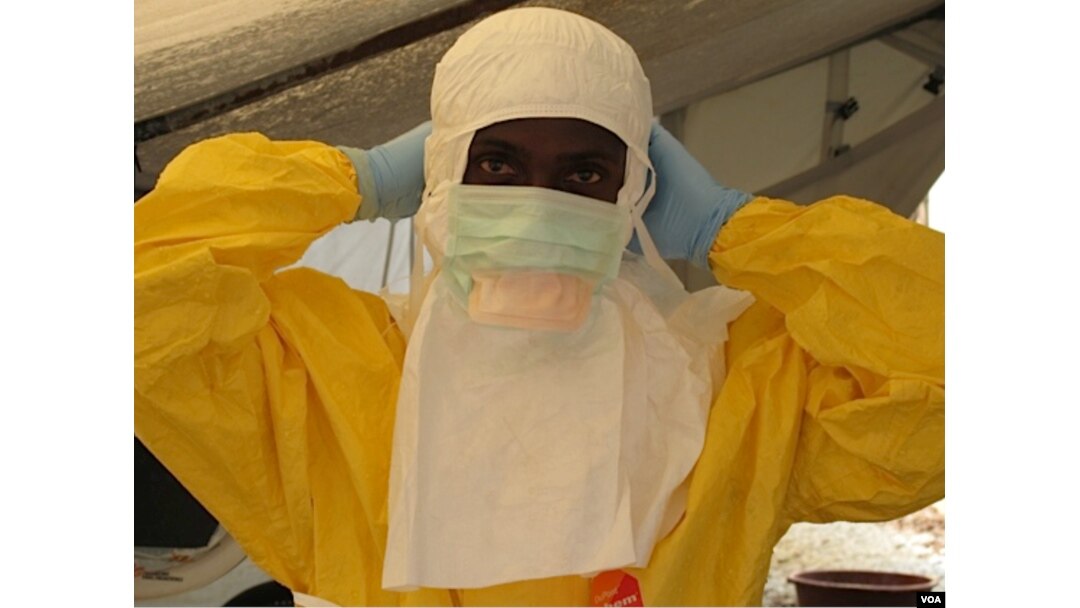 Health care workers' protective gear can look frightening. Here, a worker prepares to care for Ebola patients at the Doctors Without Borders treatment unit at Donka hospital in Conakry, Guinea.