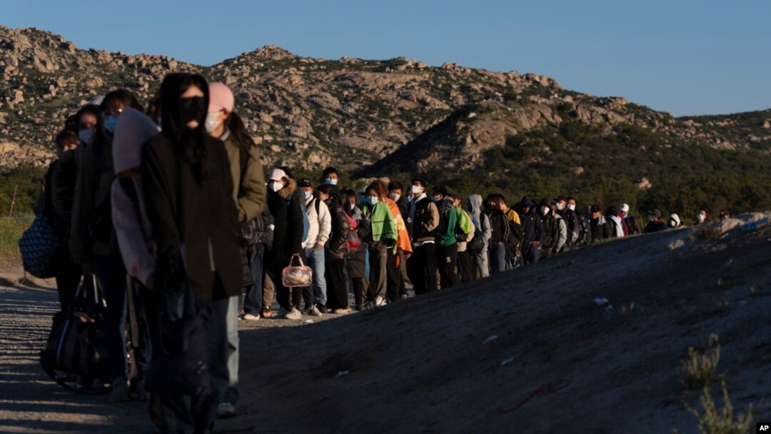 Chinese migrants wait to be processed after crossing the border with Mexico near Jacumba Hot Springs, Calif., May 8, 2024. San Diego was the busiest corridor for illegal crossings in April, according to U.S. figures.