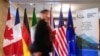 Човек поминува покрај знамињата на земјите-членки на Г7 пред состанокот на министрите за надворешни работи на Г7 во Ла Малбаи, Квебек, Канада, 12 март 2025 година.