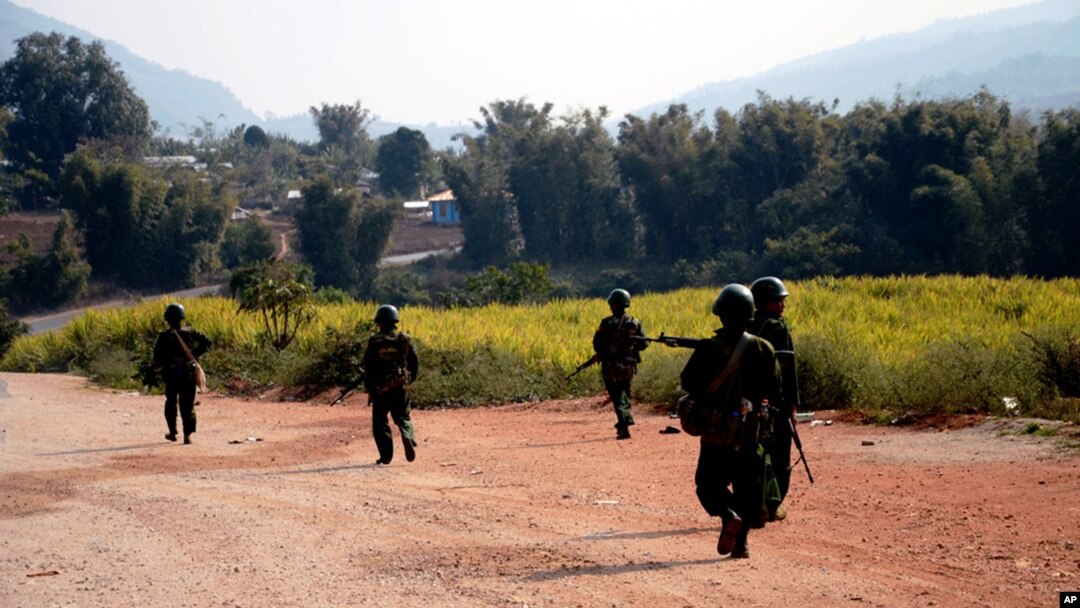 FILE - Myanmar army soldiers carrying weapons patrol on a road as part of operations against ethnic rebels, in Kokang, northeastern Shan State, more than 800 kilometers (500 miles) northeast of Yangon, Feb. 17, 2015.