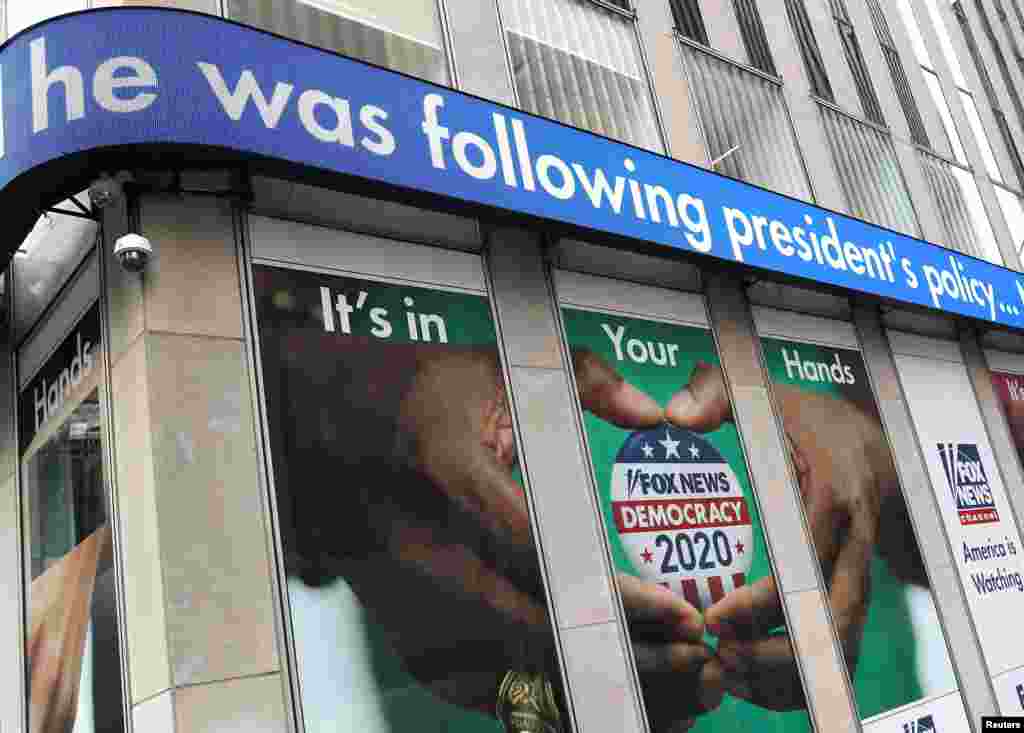 Headlines from the testimony of U.S. Ambassador to the European Union Gordon Sondland to a House Intelligence Committee hearing as part of the impeachment inquiry into U.S. President Donald Trump are seen on a news display outside Fox News headquarters in New York.