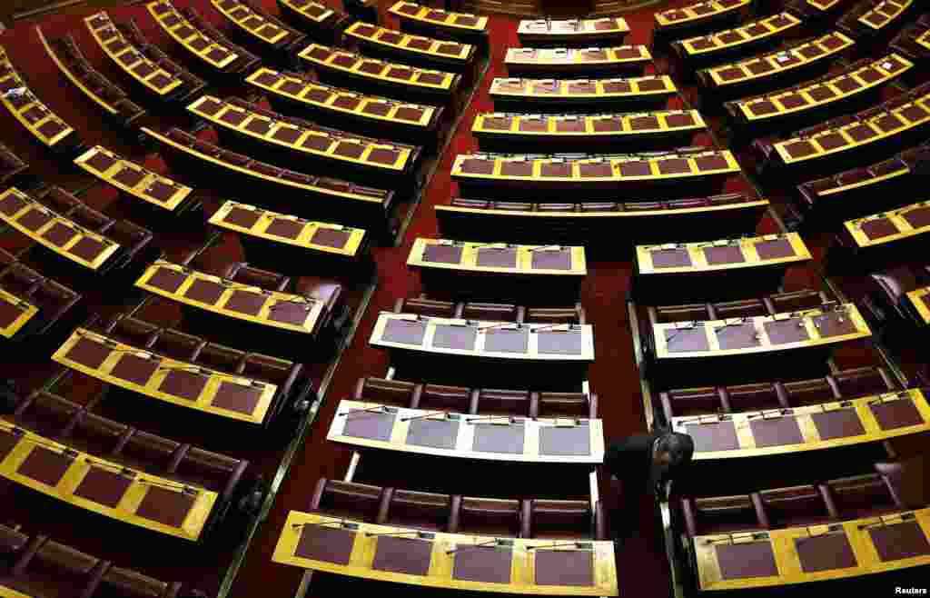 The last of 300 lawmakers departs from the main parliament hall after the last round of a presidential vote in Athens, Dec. 29, 2014. 