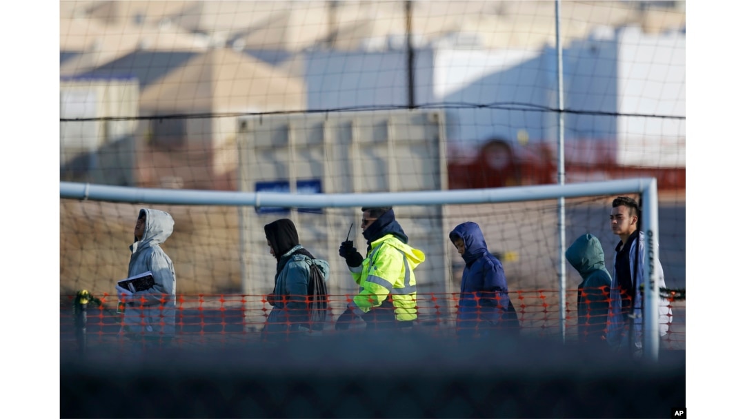 Teen migrants walk in line inside the Tornillo detention camp in Tornillo, Texas, Dec. 13, 2018.