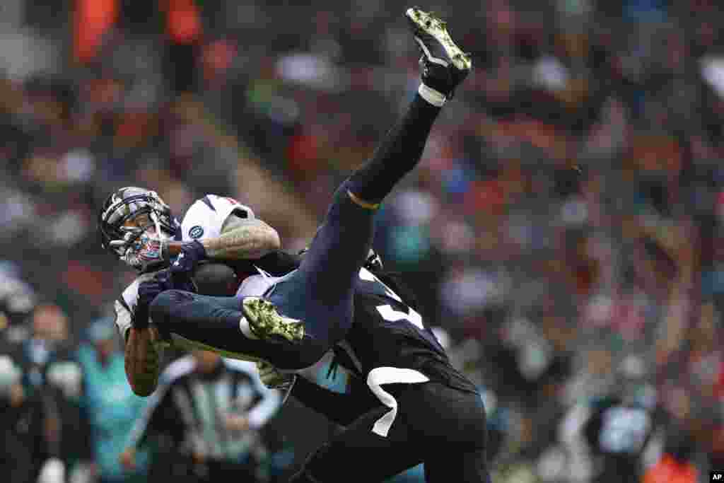 Jacksonville Jaguars cornerback Tre Herndon (37) hits Houston Texans wide receiver Kenny Stills (12) during the first half of an NFL football game at Wembley Stadium in London.