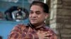 FILE - Ilham Tohti, an outspoken scholar of China's Turkic Uighur ethnic minority, speaks during an interview at his home in Beijing, China.