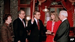 FILE - Sen. Jocelyn Burdick, D-N.D., left, watches Sen. Byron Dorgan, D-N.D., re-enact his Senatorial oath, Dec. 15, 1992. Burdick, who became the first woman to represent North Dakota in the U.S. Senate, died Dec. 26, 2019. She was 97.