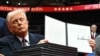 Trump mostra um dos decretos que assinou ontem