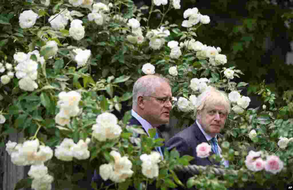 Britain's Prime Minister Boris Johnson, right, walks with Australian Prime Minister Scott Morrison after their meeting, in the garden of 10 Downing Street in London.