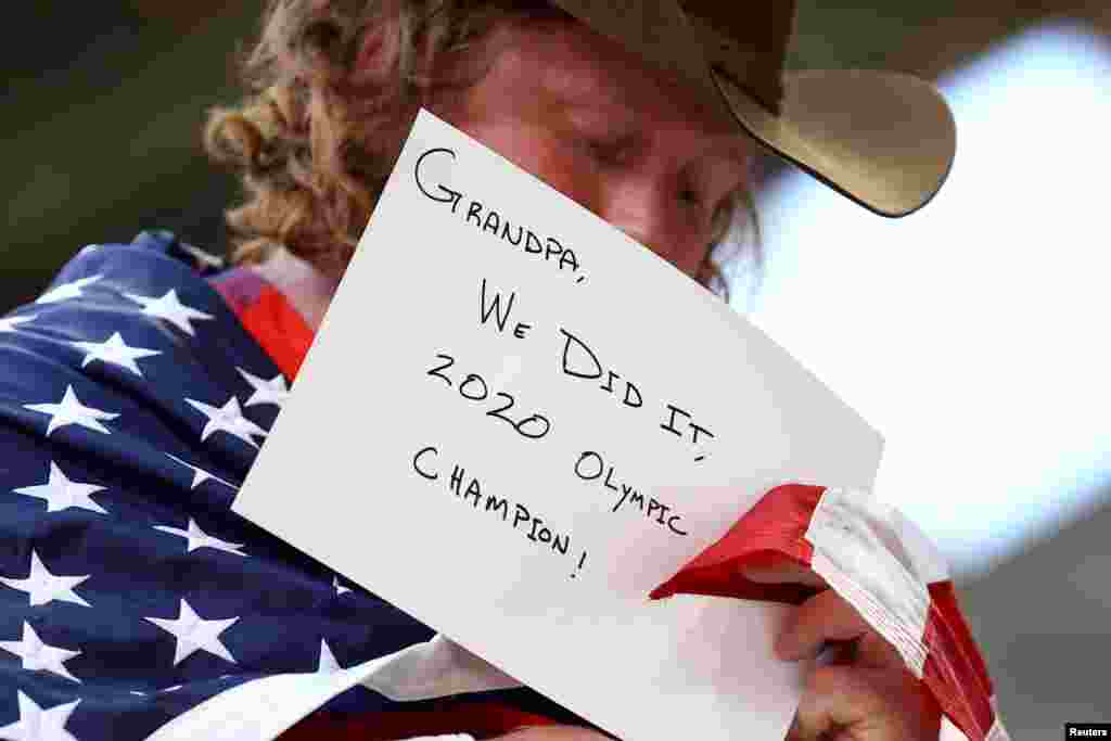 Ryan Crouser of the United States holds a message for his grandfather after winning the gold medal in the men's shot put final at the Tokyo 2020 Olympics.