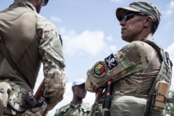 A member of the close protection unit for Central African Republic (CAR) President Touadera, composed by Russian private security company operatives from Sewa Security, are seen in Berengo, CAR on August 4, 2018.