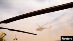 FILE - An Iraqi Army helicopter flies during a military operation against Islamic State militants in the desert of Anbar, Iraq, April 23, 2022.