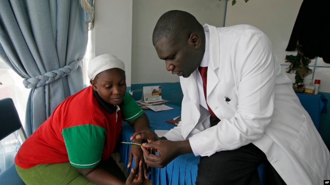 Dr. Aron Sikuku, right, explains family planning options to Beatrice Ravonga in Nairobi, Kenya. (Jan. 29, 2009 file)