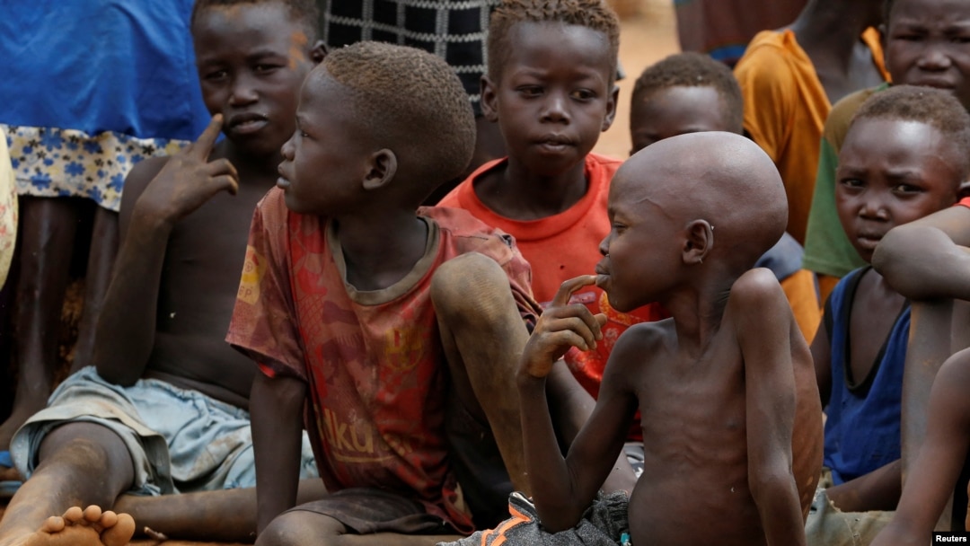 FILE - Orphans and children separated from their parents in Kadugli gather for food at an internally displaced persons camp in Boram County, Nuba Mountains, South Kordofan, Sudan, June 22, 2024.