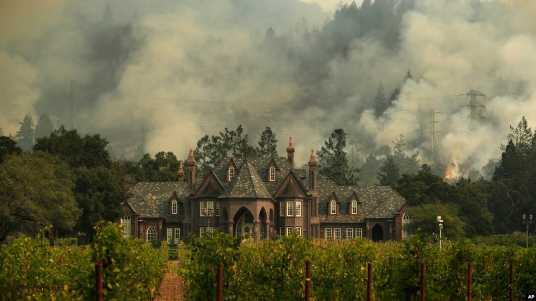 A wildfire burns behind a winery, Oct. 14, 2017, in Santa Rosa, Calif. 