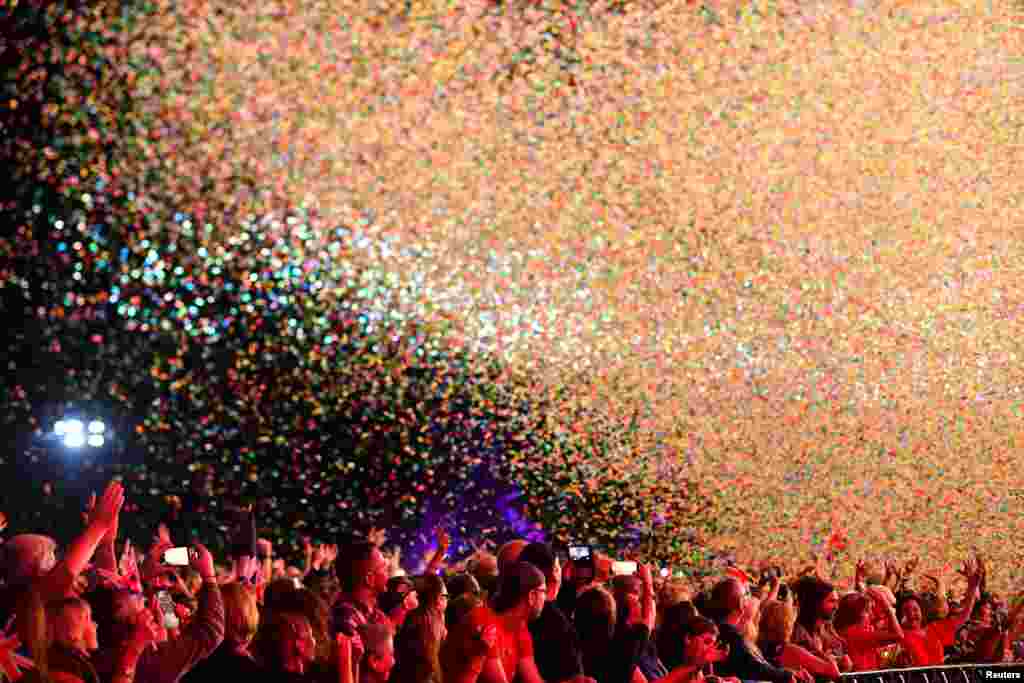 Confetti falls on revelers during 'The Last Night of the Proms' celebration in Hyde Park, London, Sept. 14, 2018.
