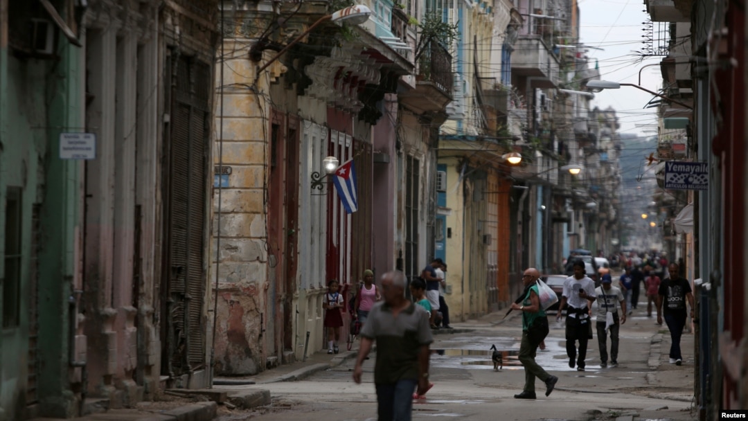 FILE - People walk on a street in Havana, Cuba, April 10, 2019. 